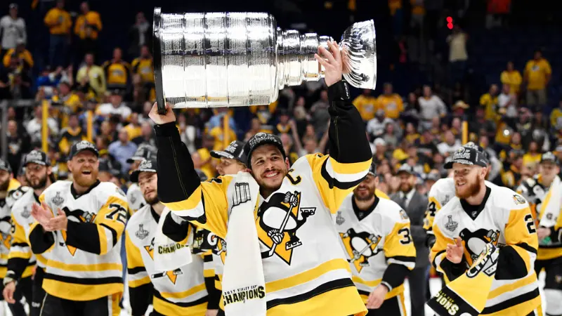 Sidney Crosby lifts his first Stanley Cup